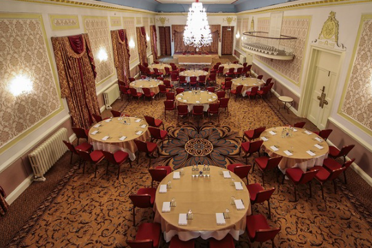 The Old Ship Hotel ballroom set for a banquet; classic high-ceilinged event space for weddings. - Banner