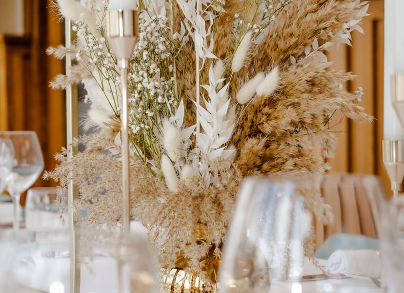 Sophisticated event tablescape with dried floral centerpiece for upscale corporate or gala events.