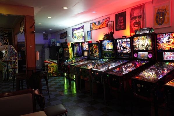 Retro arcade venue with neon lights for team building and networking events.