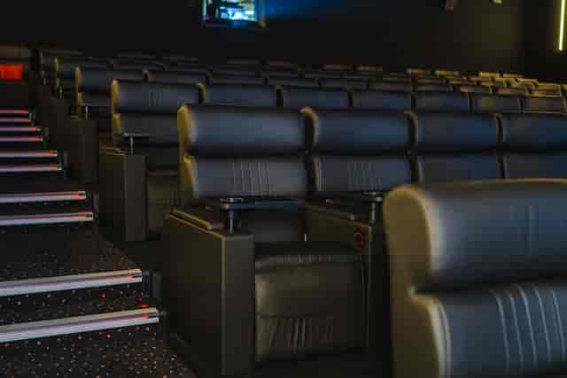 Luxury tiered cinema with leather reclining seats for corporate events and product reveals.