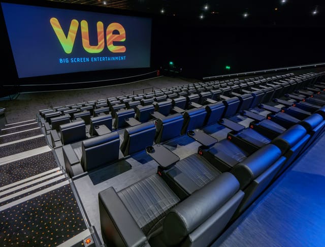 Corporate presentation in Vue Edinburgh cinema auditorium with tiered seating.