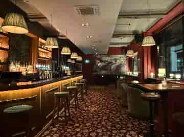 Moody lounge bar for professional networking reception and corporate cocktail hour.