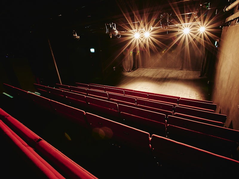 Spielman Theatre black-box stage with dramatic lighting for corporate keynotes and product launches.