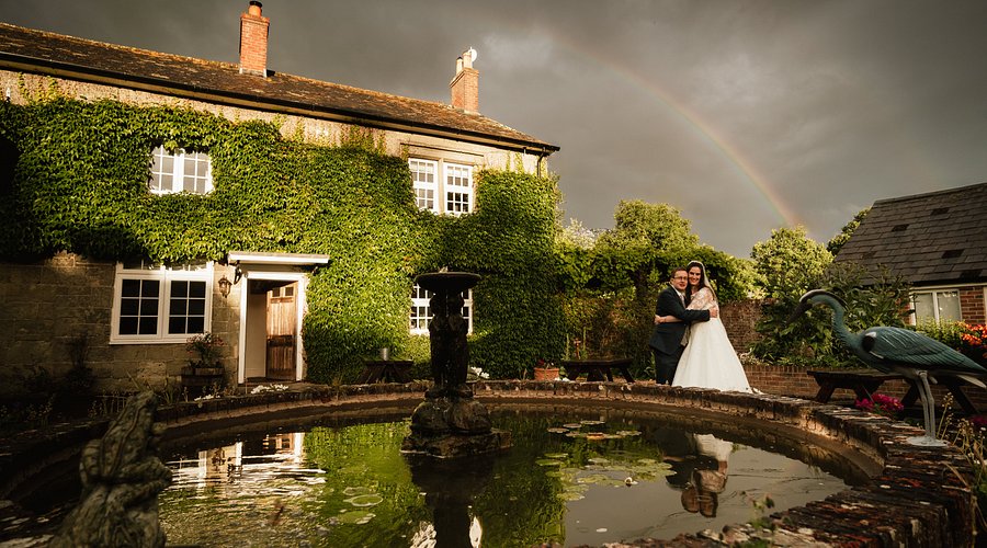 Rustic stone wedding venue at The Coppleridge Inn with iconic water feature. - Banner
