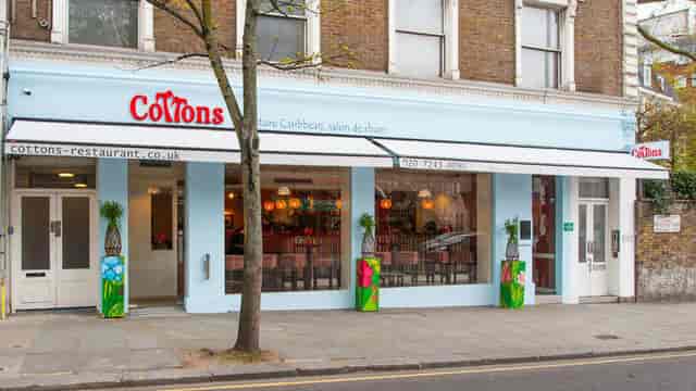 Vibrant Caribbean-themed Cottons Notting Hill storefront for team social or breakout dinner venue.
