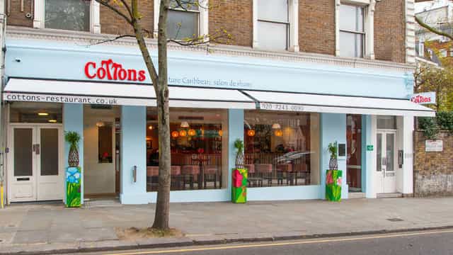 Vibrant Caribbean-themed Cottons Notting Hill storefront for team social or breakout dinner venue.