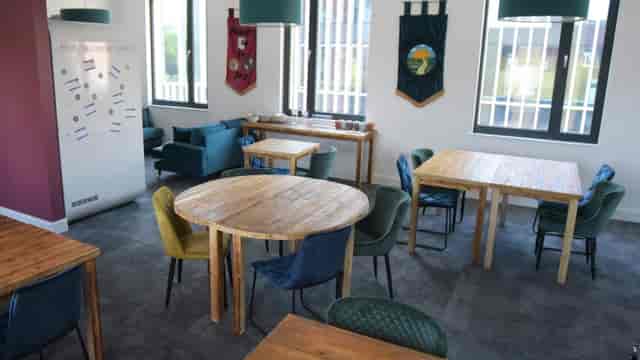 Versatile meeting space with tables for collaborative workshops and corporate networking events.