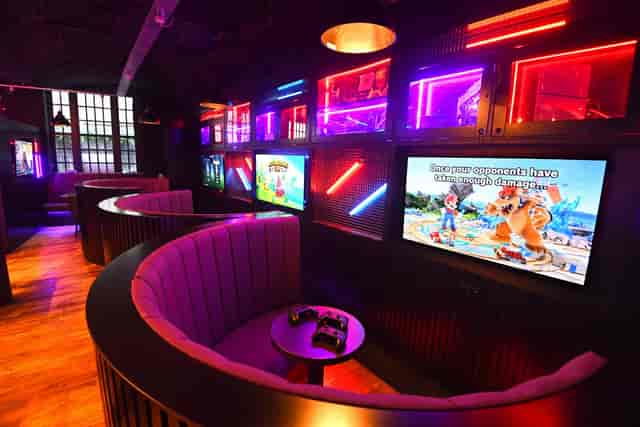 Gaming console booths at Pixel Bar Manchester for corporate team-building and networking events.
