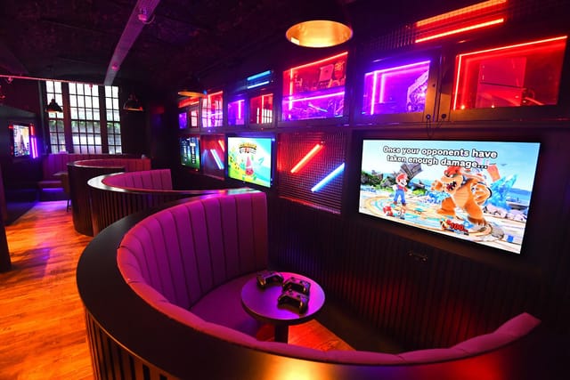 Gaming console booths at Pixel Bar Manchester for corporate team-building and networking events.