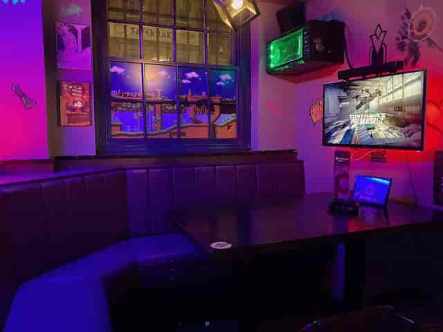 Console booths at Pixel Bar Manchester: immersive AV gaming space for corporate events and networking.