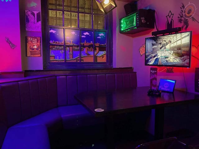 Console booths at Pixel Bar Manchester: immersive AV gaming space for corporate events and networking.