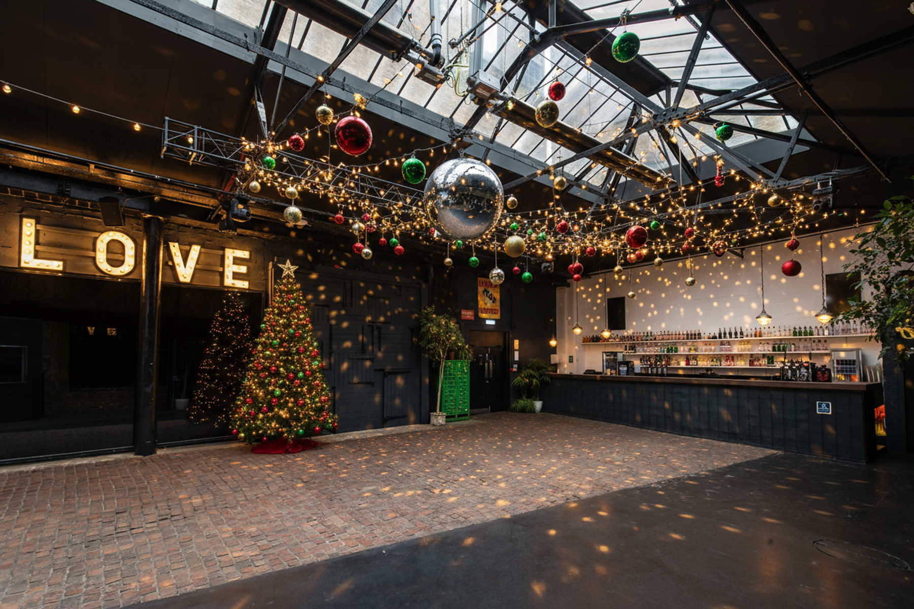 Festive event space with "LOVE" sign and disco ball at Electrowerkz for gatherings.