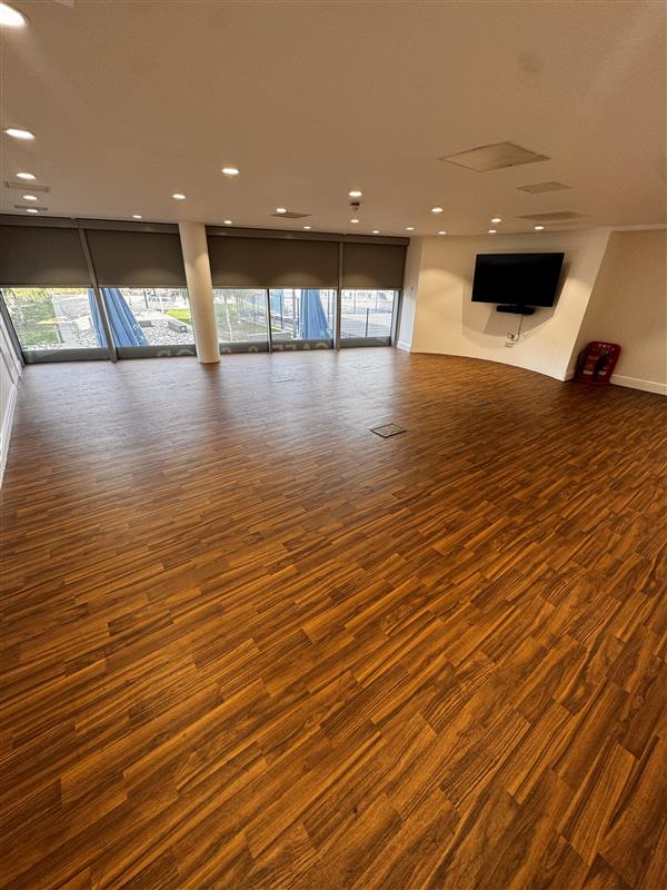 Mezzanine event space in London Cable Car with polished floors, ideal for meetings and gatherings.