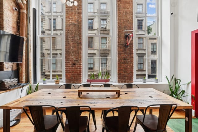 Stylish Mercer Conference Room with large wooden table, perfect for corporate meetings.