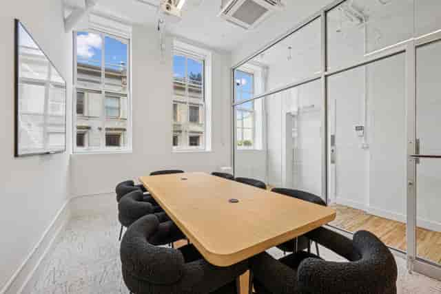 "Mercer Meeting Room 402 A with wooden conference table for corporate brainstorming sessions"