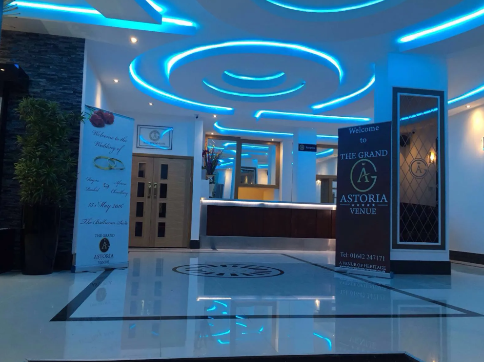 Corporate event venue entrance with sleek lighting, ideal for weddings and celebrations. - Banner