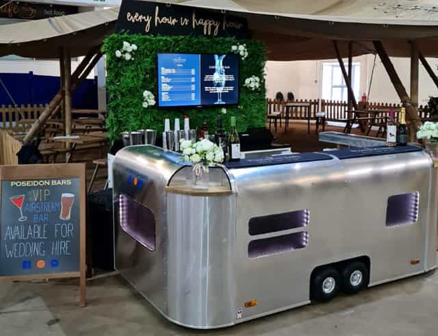 Modern mobile bar setup with floral decor for events and weddings.