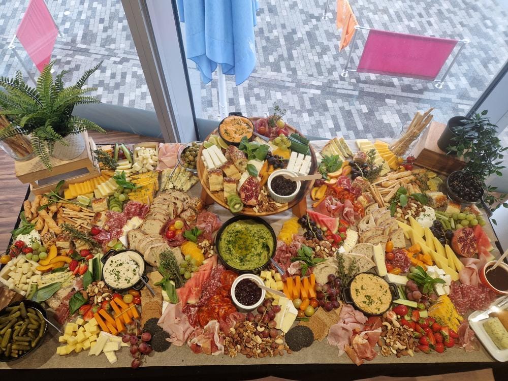 Christmas party charcuterie board with cheeses and meats at IFS Cloud Cable Car, London. - Banner