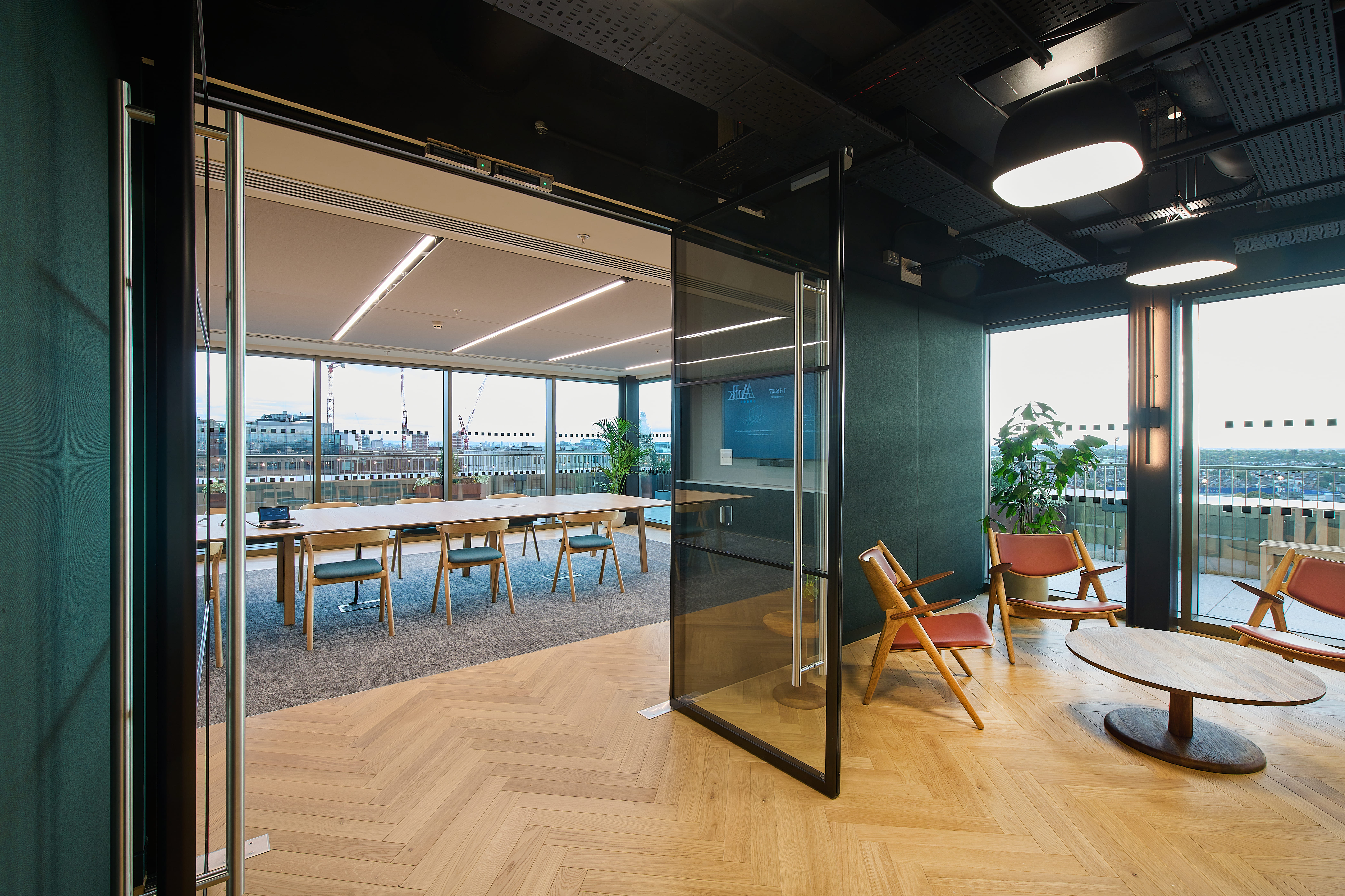 High-end hybrid boardroom and breakout lounge for corporate offsite meetings. - Banner