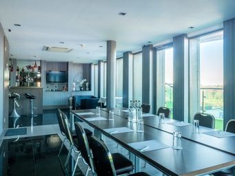 Sky Lounge meeting space with large windows, perfect for corporate events and networking.