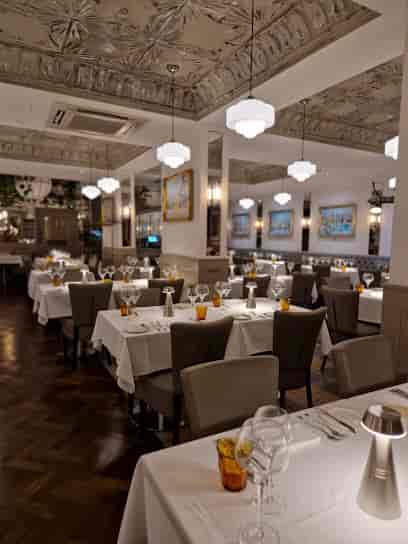 Elegant Bar & Grill restaurant, formal event table setup with crisp linens, fine dining.