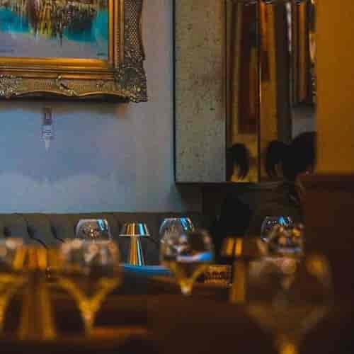 Private dining with tufted banquette seating for luxury networking and boutique events.