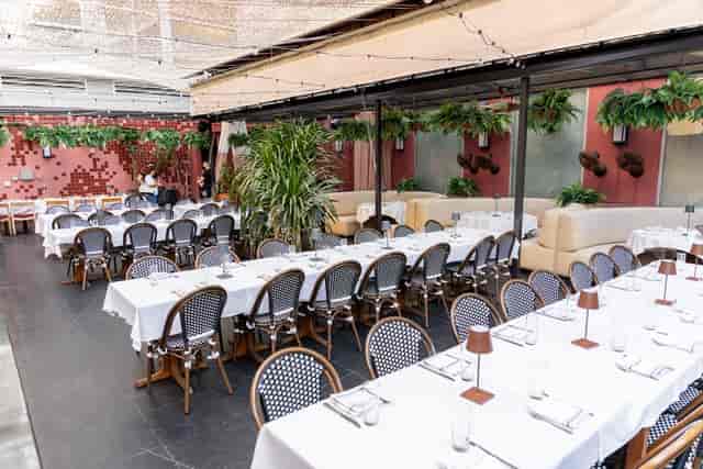 Stylish outdoor restaurant venue with elegant table settings, ideal for receptions and gatherings.