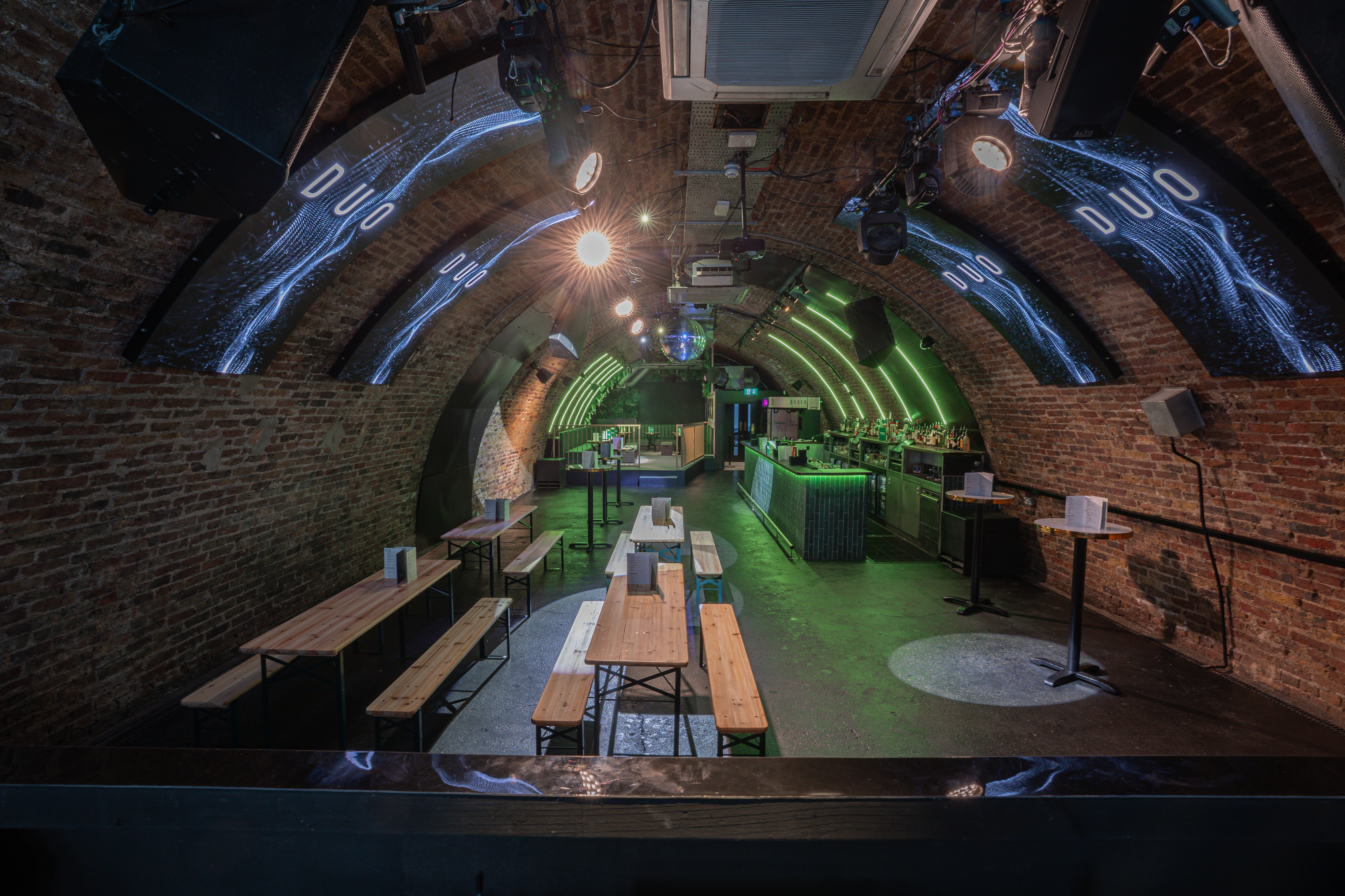 Stylish event space with arched brick interior, ideal for parties and corporate functions.