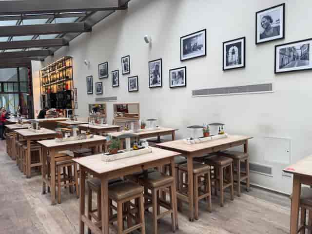 Ground Floor Pasta Kitchen at Vapiano Tower Bridge, inviting event space with wooden tables.