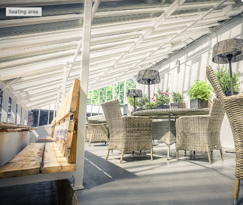 Outdoor meeting space in Walled Garden West Wycombe with wicker furniture, perfect for networking events. - Banner