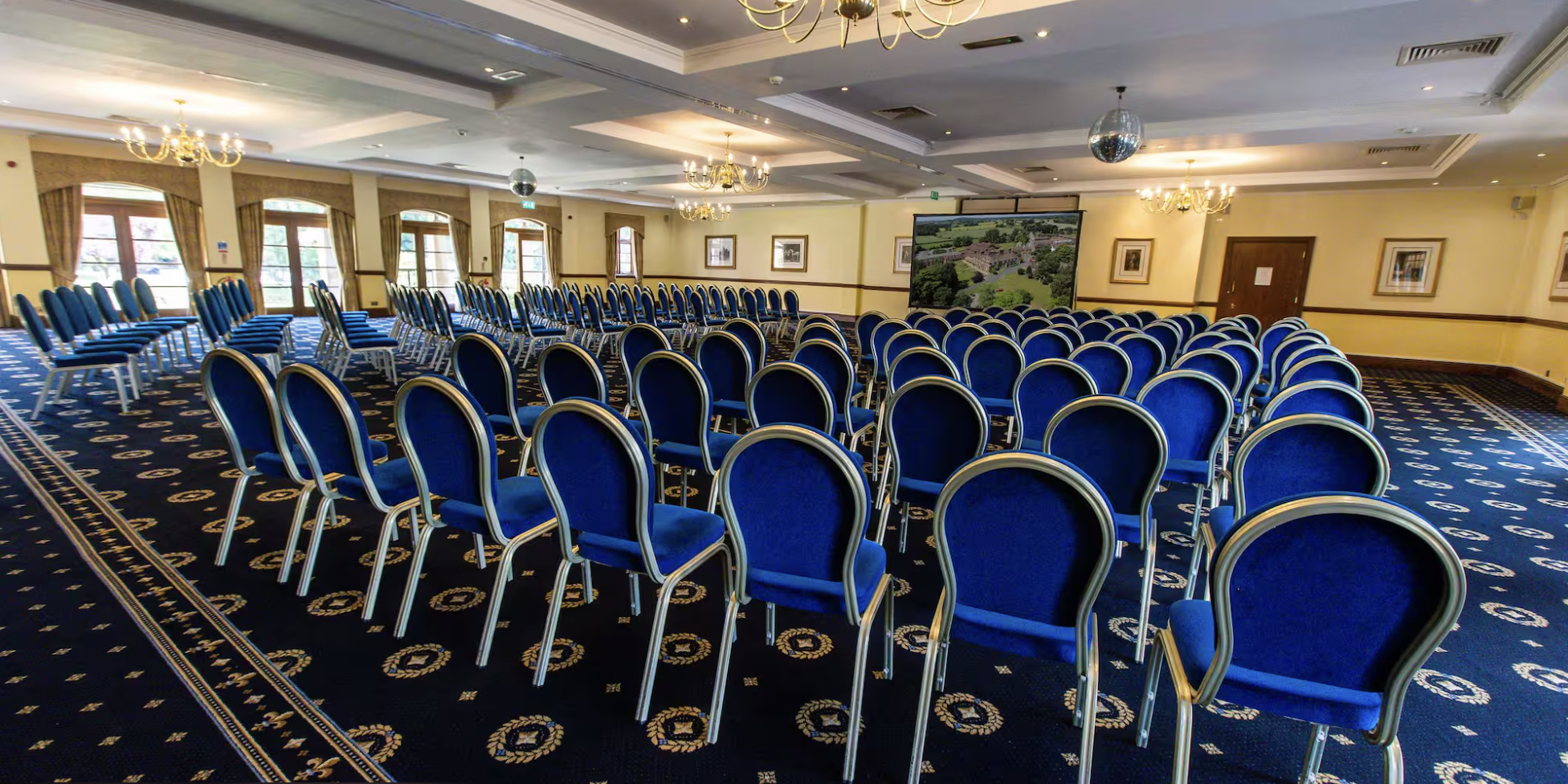 Lakeside Suite meeting space with blue chairs, ideal for conferences and presentations.