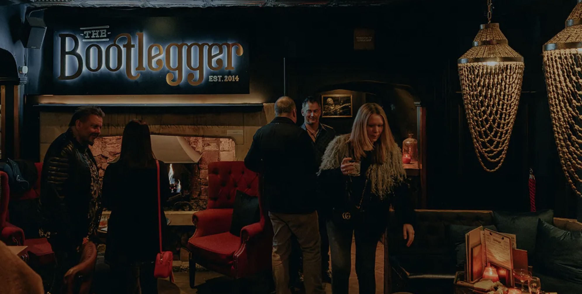 Full venue hire at Bootlegger Bath with fireside decor for upscale networking event reception. - Banner