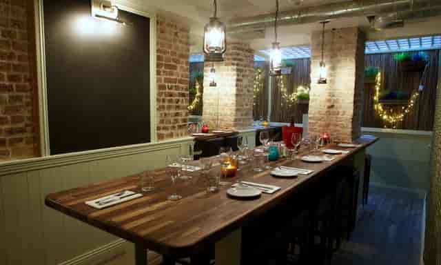 Private dining room with exposed brick for exclusive client mixers and breakout sessions.