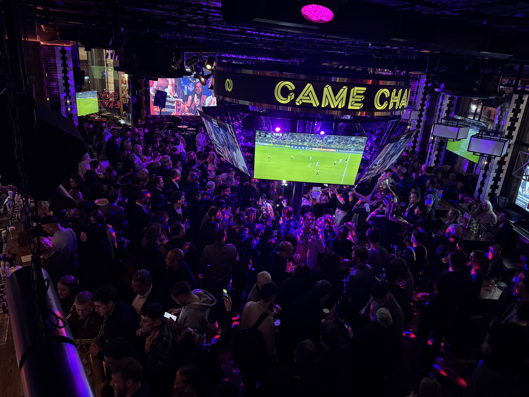 Vibrant BOX Piccadilly event space with large screens for sports and corporate gatherings. - Banner