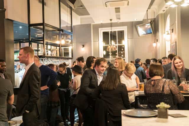 Vibrant Thirsty Scholar venue with warm lighting, ideal for networking events.