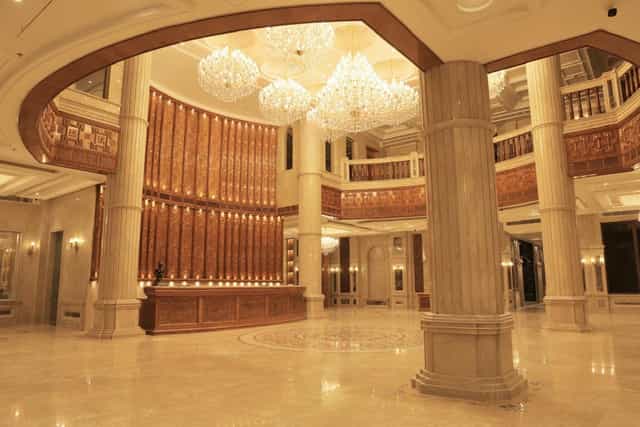 Grand Mandap lobby with ornate chandeliers for luxury gala and corporate event check-in.