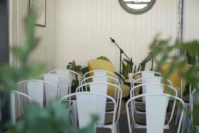 Cozy event space with chairs and greenery for meetings and presentations in West Digital Studios.
