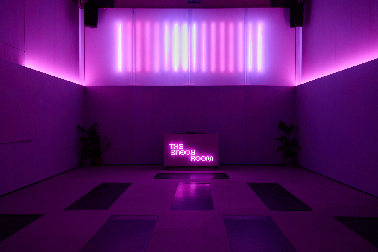 Modern immersive wellness event space at The Rogue Room with dramatic LED lighting. - Banner