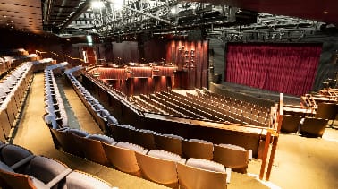 Tiered BEAM Stage One auditorium with production rigging for corporate presentations and events.