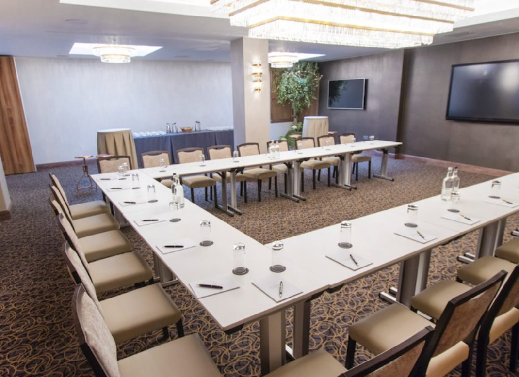 Meeting room with U-shaped seating in The Montcalm Royal London House for corporate events.