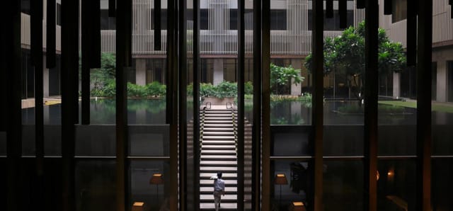 Elegant ballroom atrium with staircase, perfect for corporate gatherings and networking events.