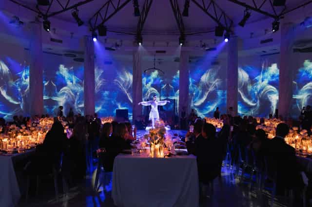 Elegant gala dinner setting in IL SALONE DELLE COLONNE with candles and floral decor.