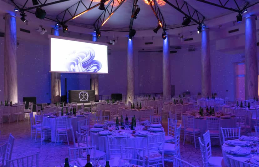 Elegant Salone delle Colonne event space with round tables, ideal for corporate gatherings.
