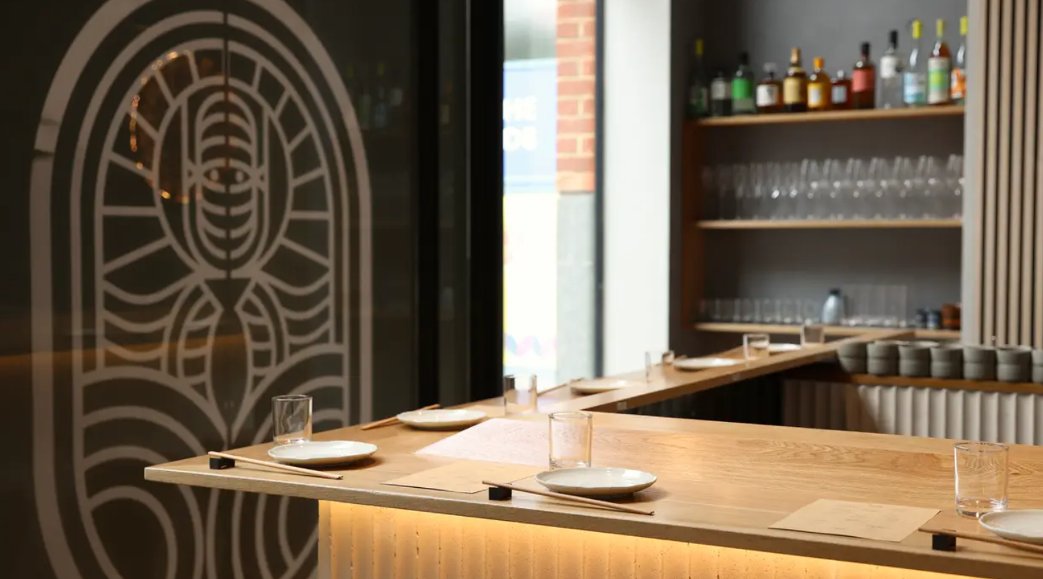 "Modern event space at Ukiyo Hand Roll Bar with sleek bar and minimalist decor."