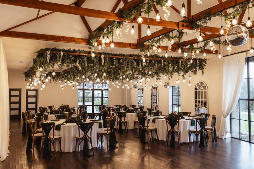Elegant event venue with round dining tables for weddings and formal gatherings.