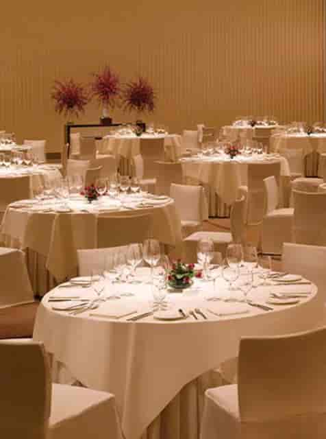 Elegant banquet setup with round tables and floral centerpieces for upscale events.