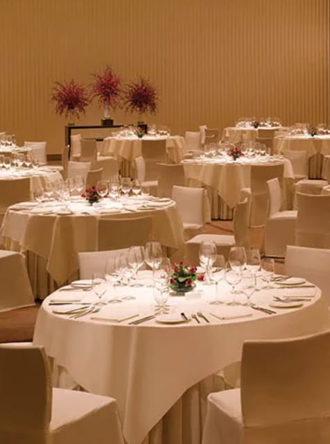 Elegant banquet setup with round tables and floral centerpieces for upscale events.