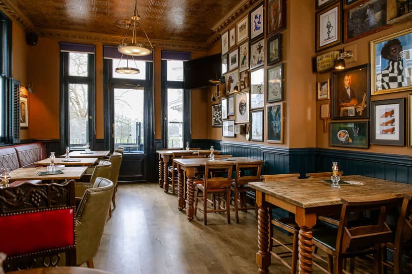 Charming Queen's Quarters event space with wooden tables for intimate gatherings.