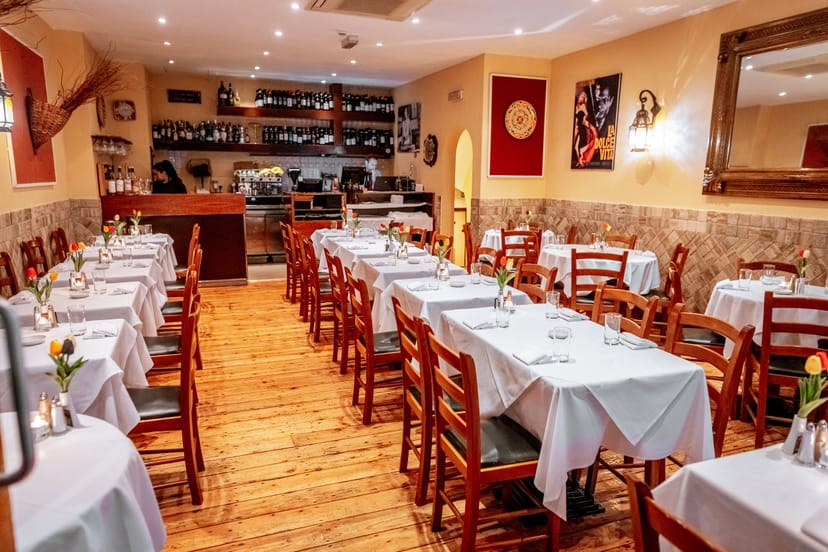 Cozy Italian restaurant setting with white tablecloths, perfect for intimate events.