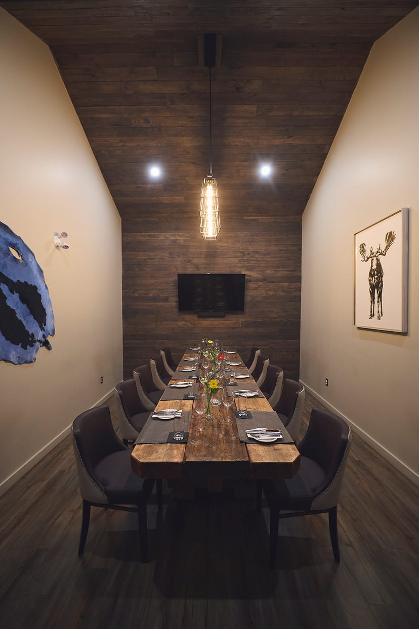 Alt text: Elegant meeting room with wooden table for corporate events at The Rock Steakhouse.